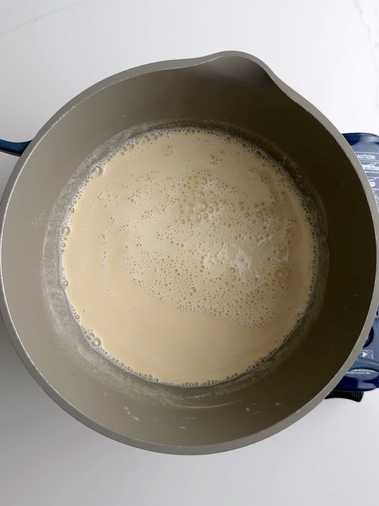 Milk in a saucepan after it has come down from a boil