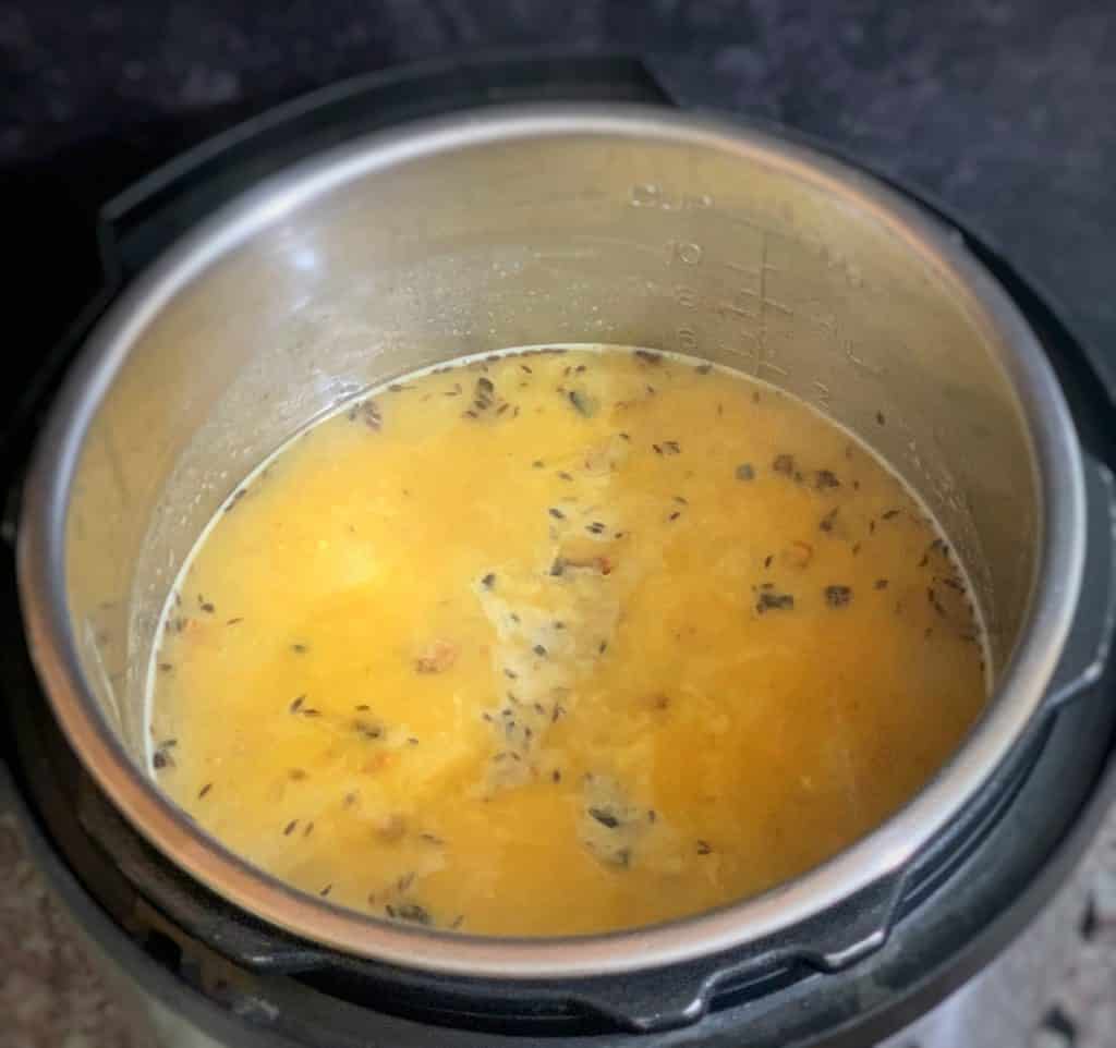 a pressure cooker filled with guyanese style dhal