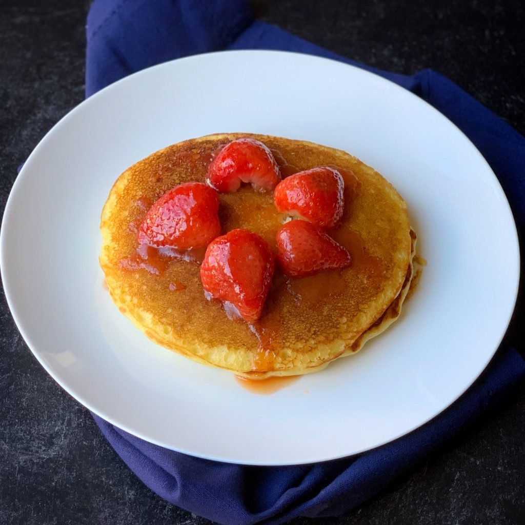 plated dairy-free pancakes topped with strawberry sauce