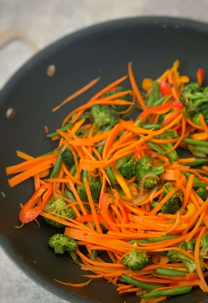 veggies being sauteed in a skillet