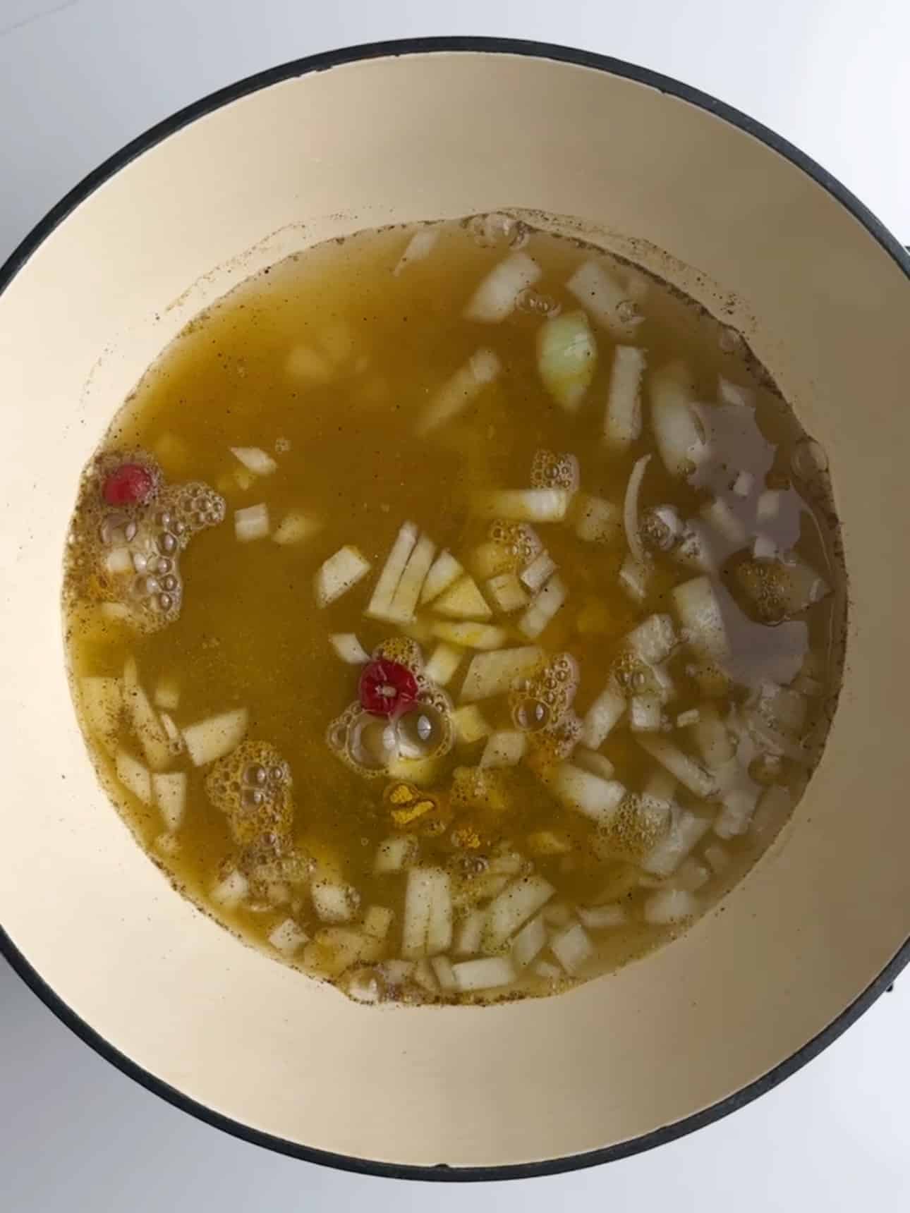 Step 2 in making the Guyanese dhal recipe. Water is added to the stock pot and all of the ingredients are somewhat visible.