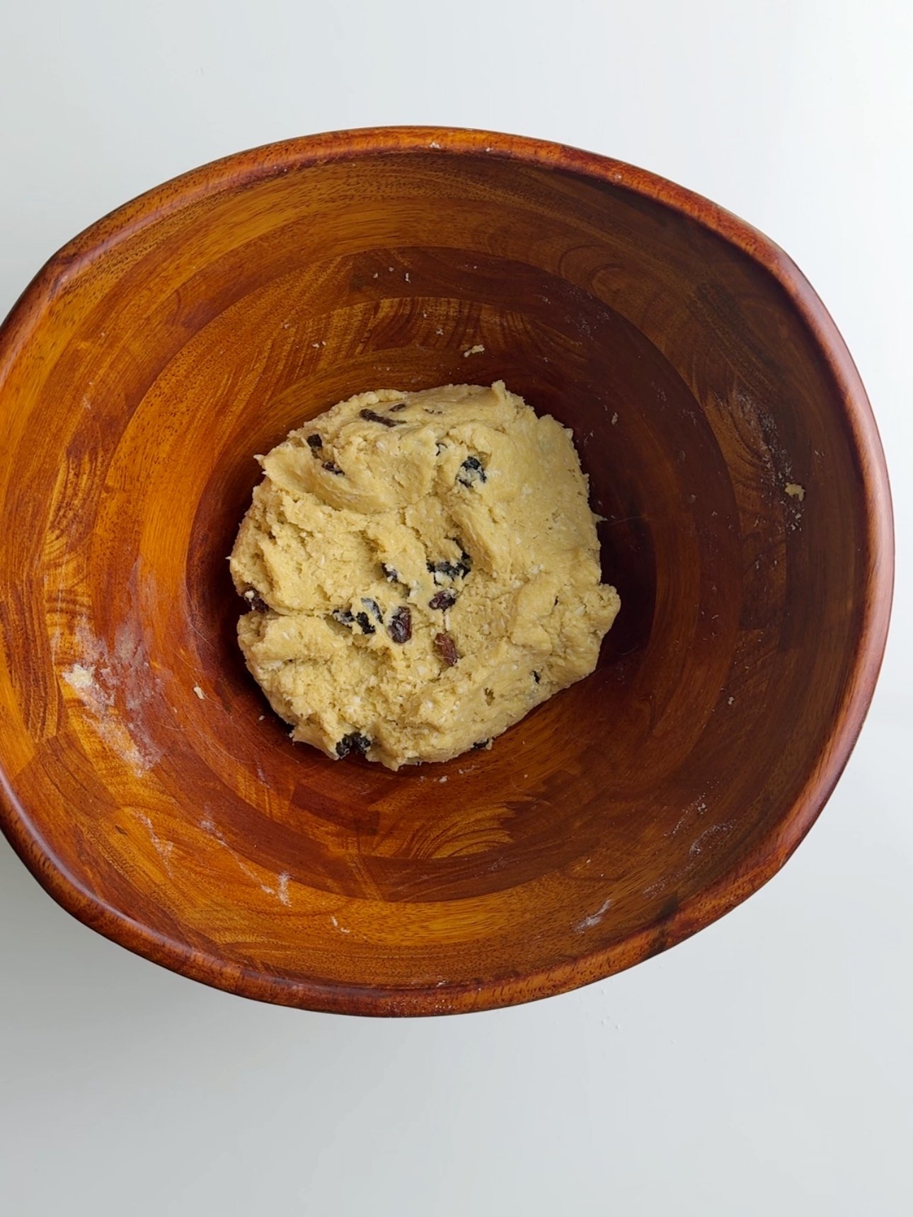 coconut buns dough in a wooden bowl