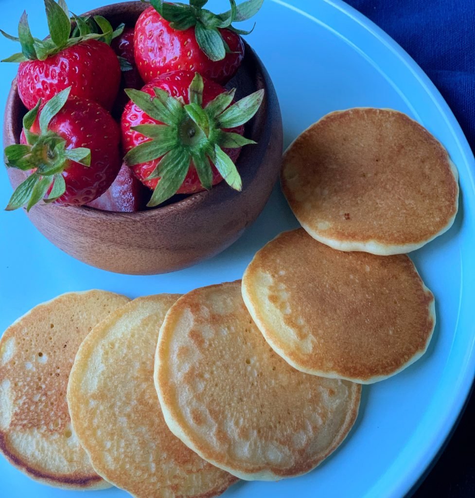 plated dairy free pancakes with a side of strawberries