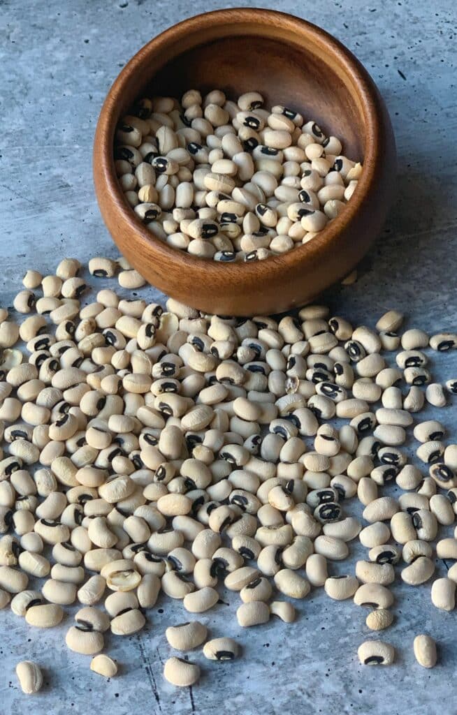dried black eyed peas in a bowl and scattered around