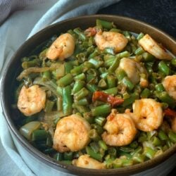 a bowl of shrimp and green beans stir fry