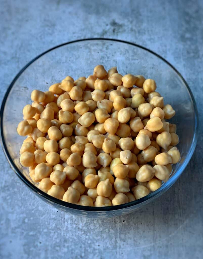 a clear bowl containing dried chickpeas