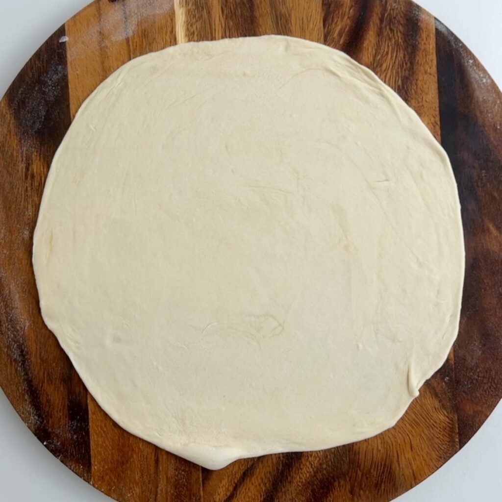 rolled out round roti on a circular round board