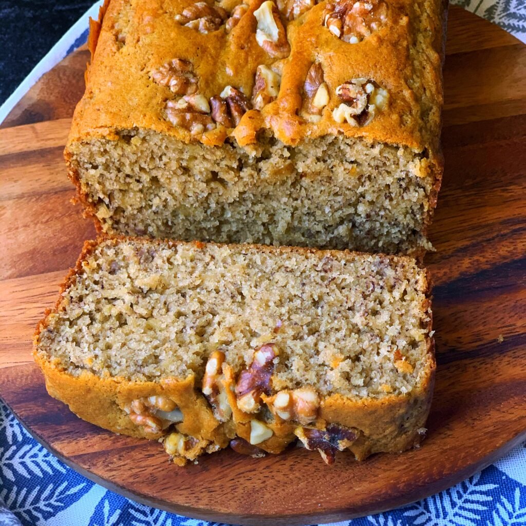 close up view of a loaf of sliced banana walnut bread