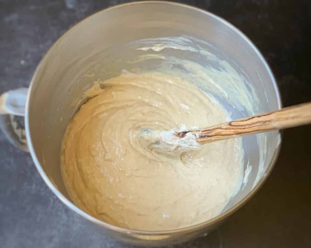 mixing banana bread batter with wooden spoon
