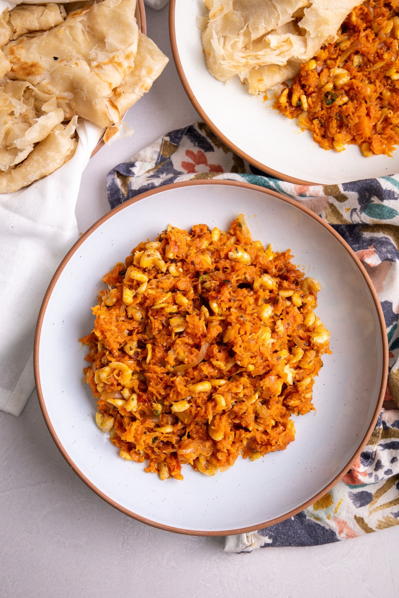 Guyanese pumpkin and shrimp with roti to the left and roti and pumpkin to the right