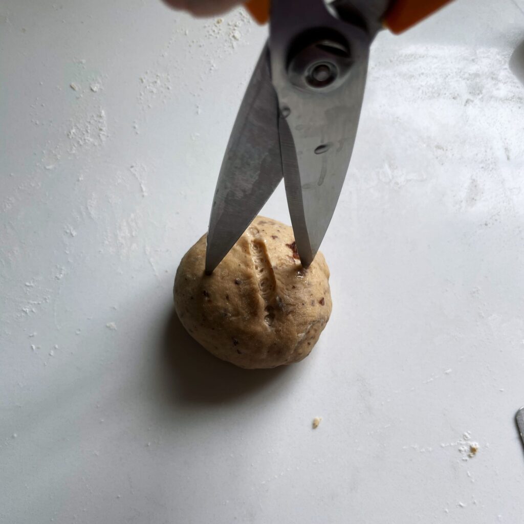 using scissors to indent cross bun dough