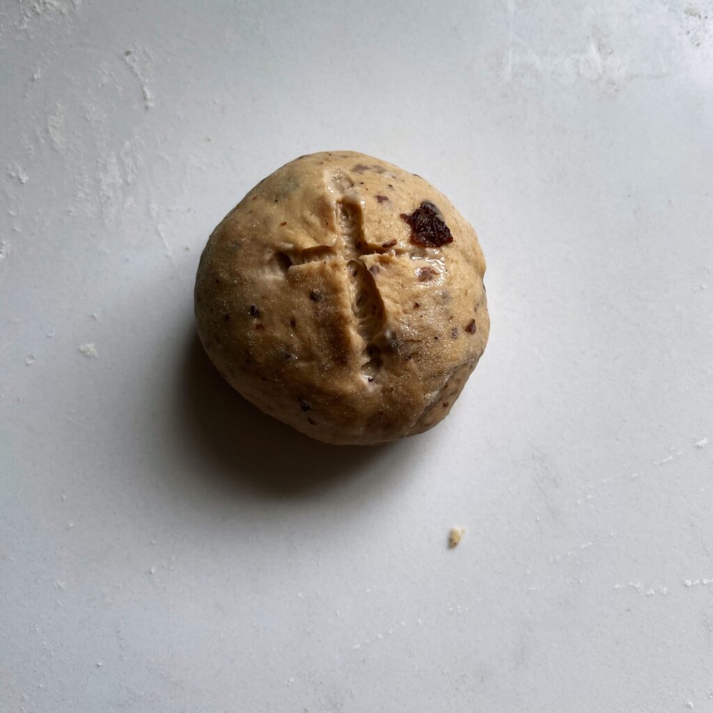 bun dough indented with cross mark