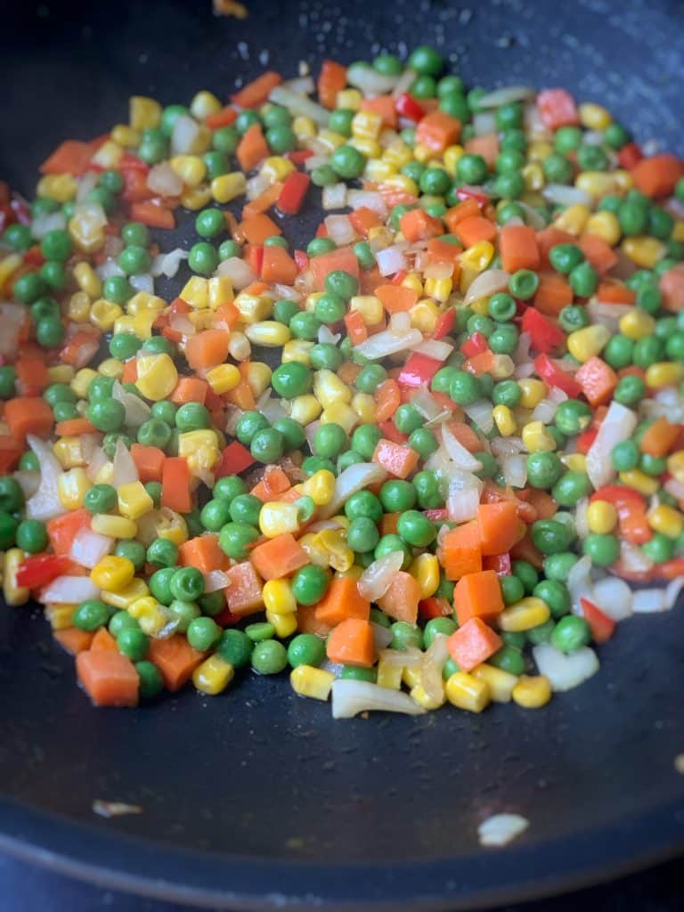 veggies sautéing in a pan