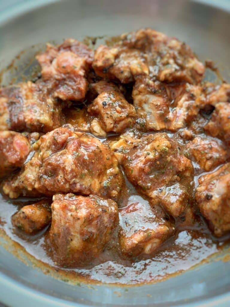 raw oxtails soaking in a marinade
