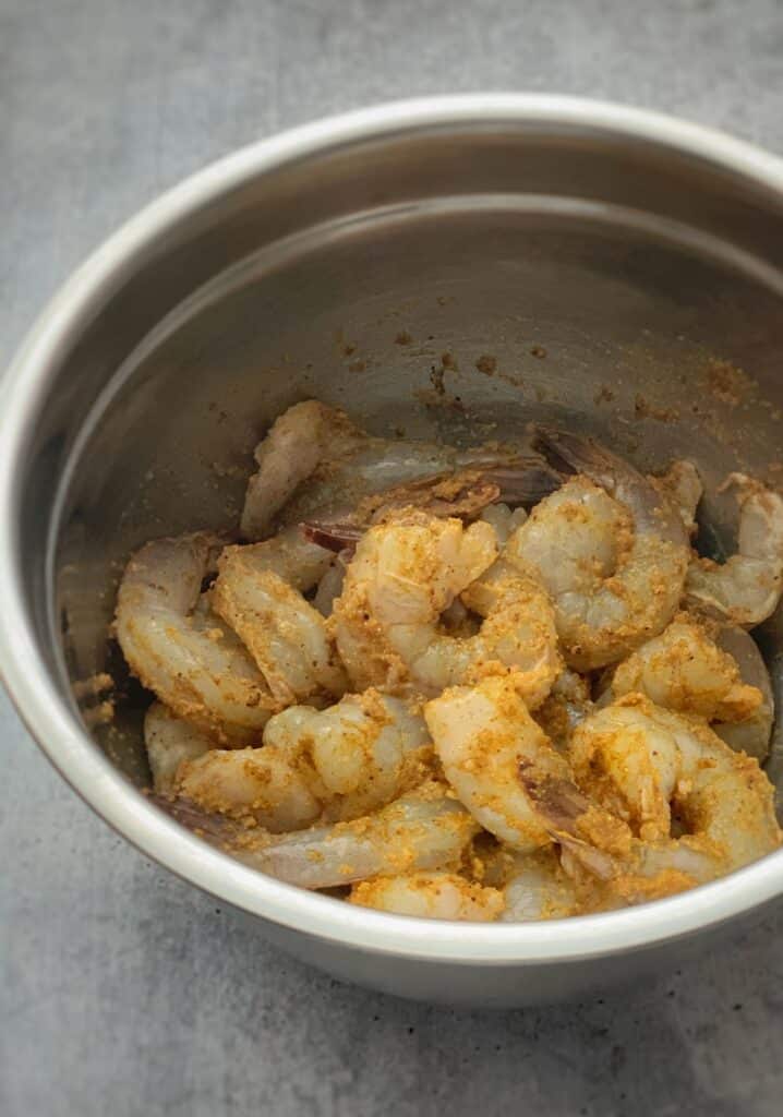 Seasoned shrimp in a metal bowl
