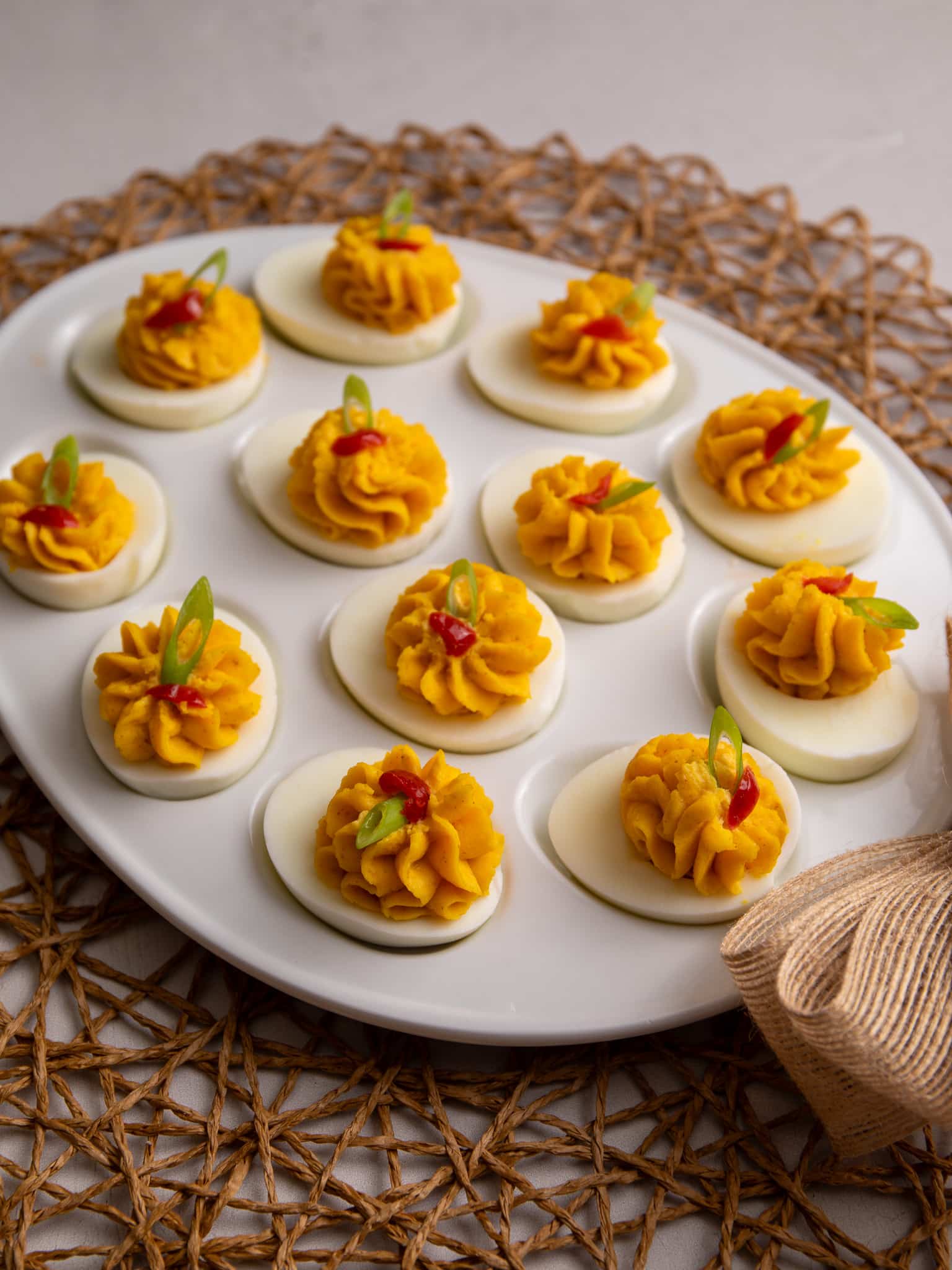 Guyanese stuffed eggs topped with scallions and wiri wiri peppers