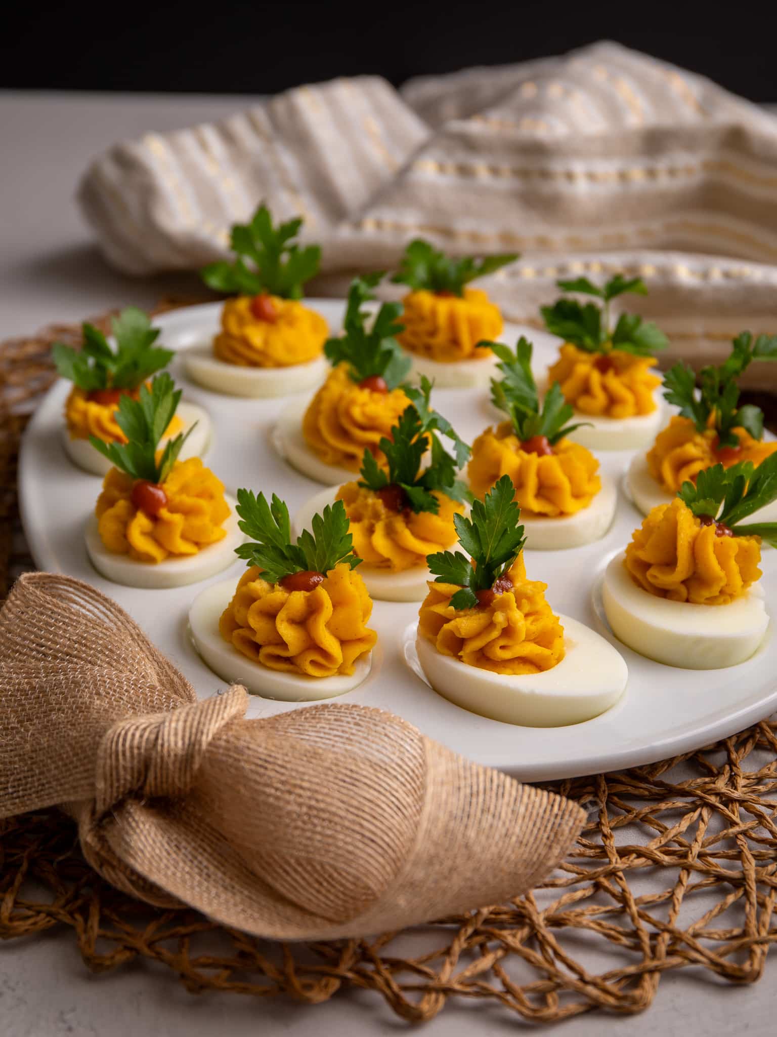 Guyanese stuffed eggs on a plate with some parsley garnish