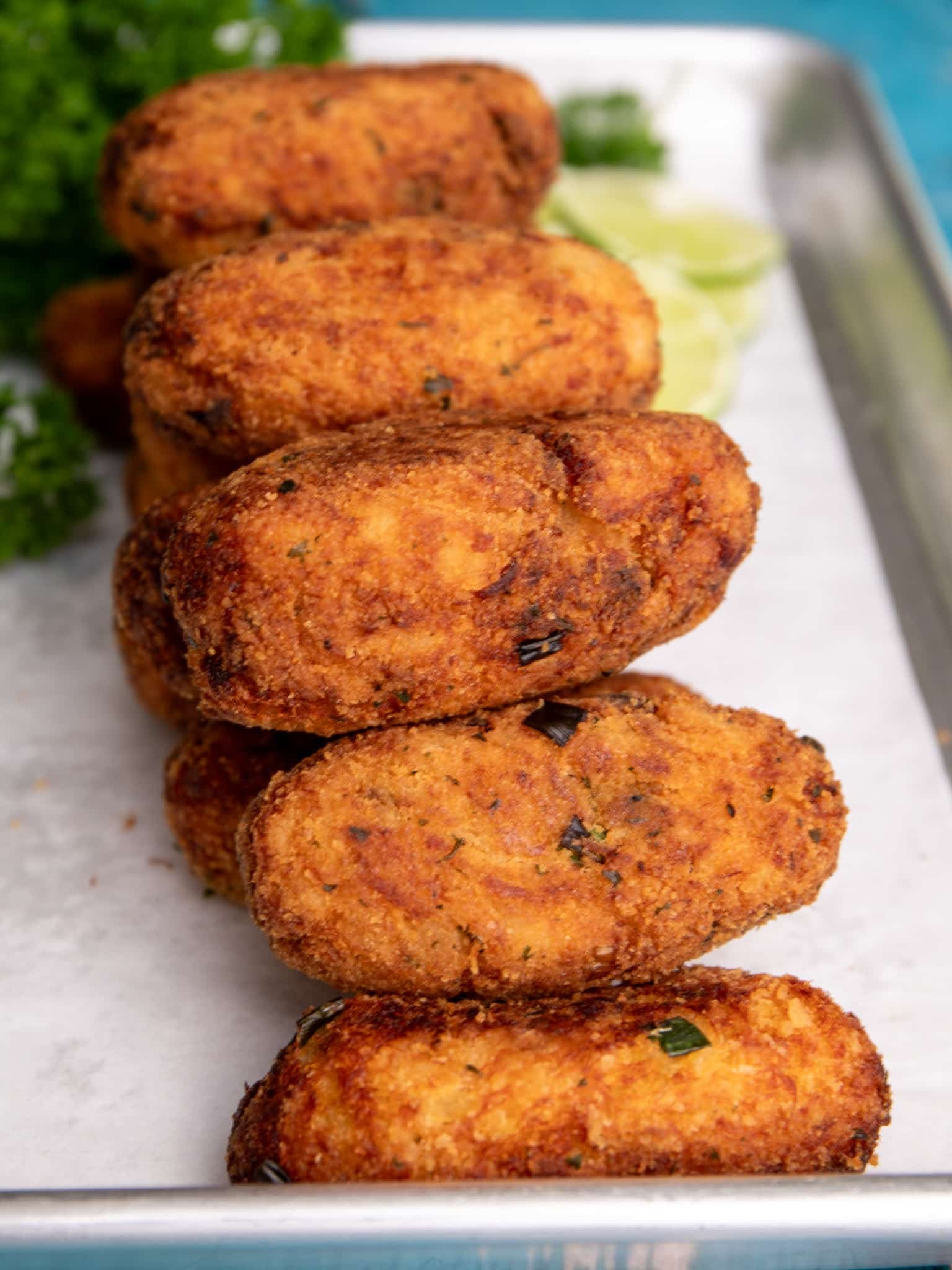 Crispy saltfish cakes served Guyanese style with croquette shape.