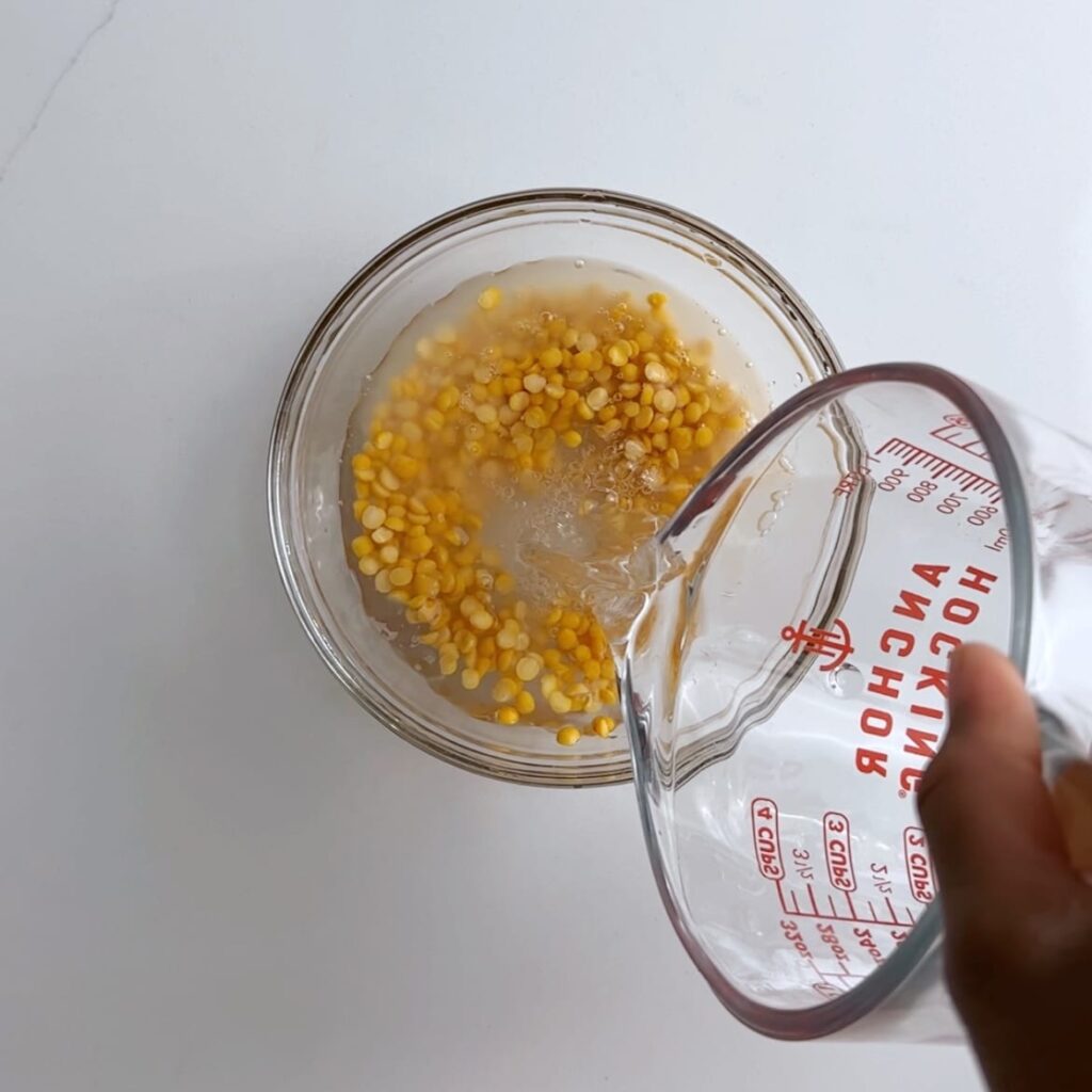 pouring water into a bowl of split peas