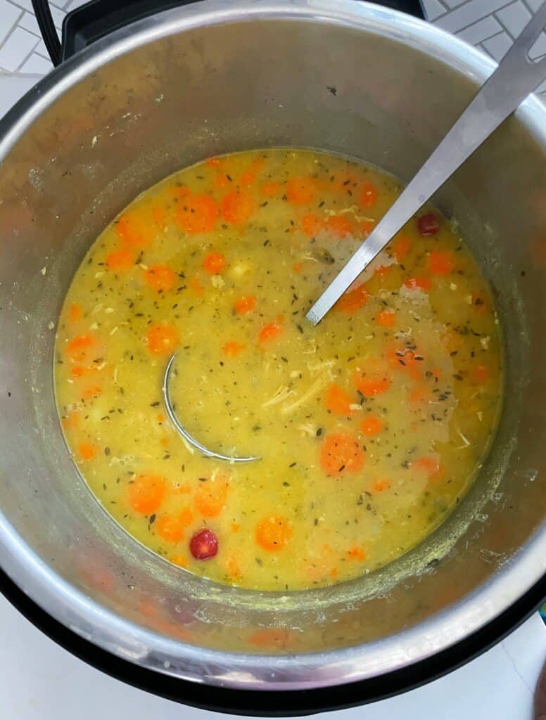 a stockpot containing Chicken Split Pea Soup with a lade inserted