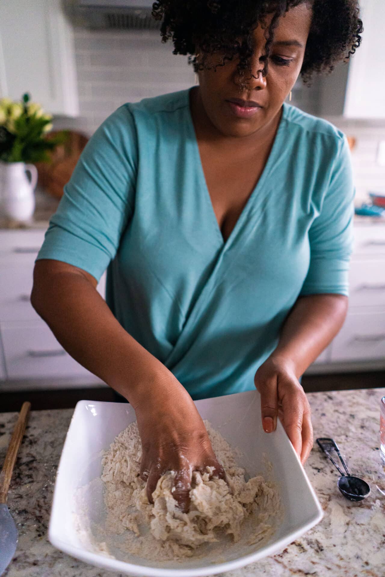 woman in blue shirt mixing dough