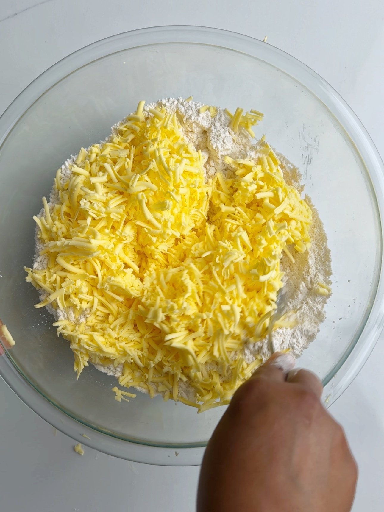 Grated butted and flour in a glass bowl