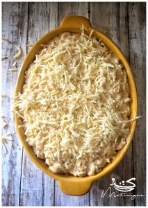 casserole dish contains unbaked macaroni and cheese