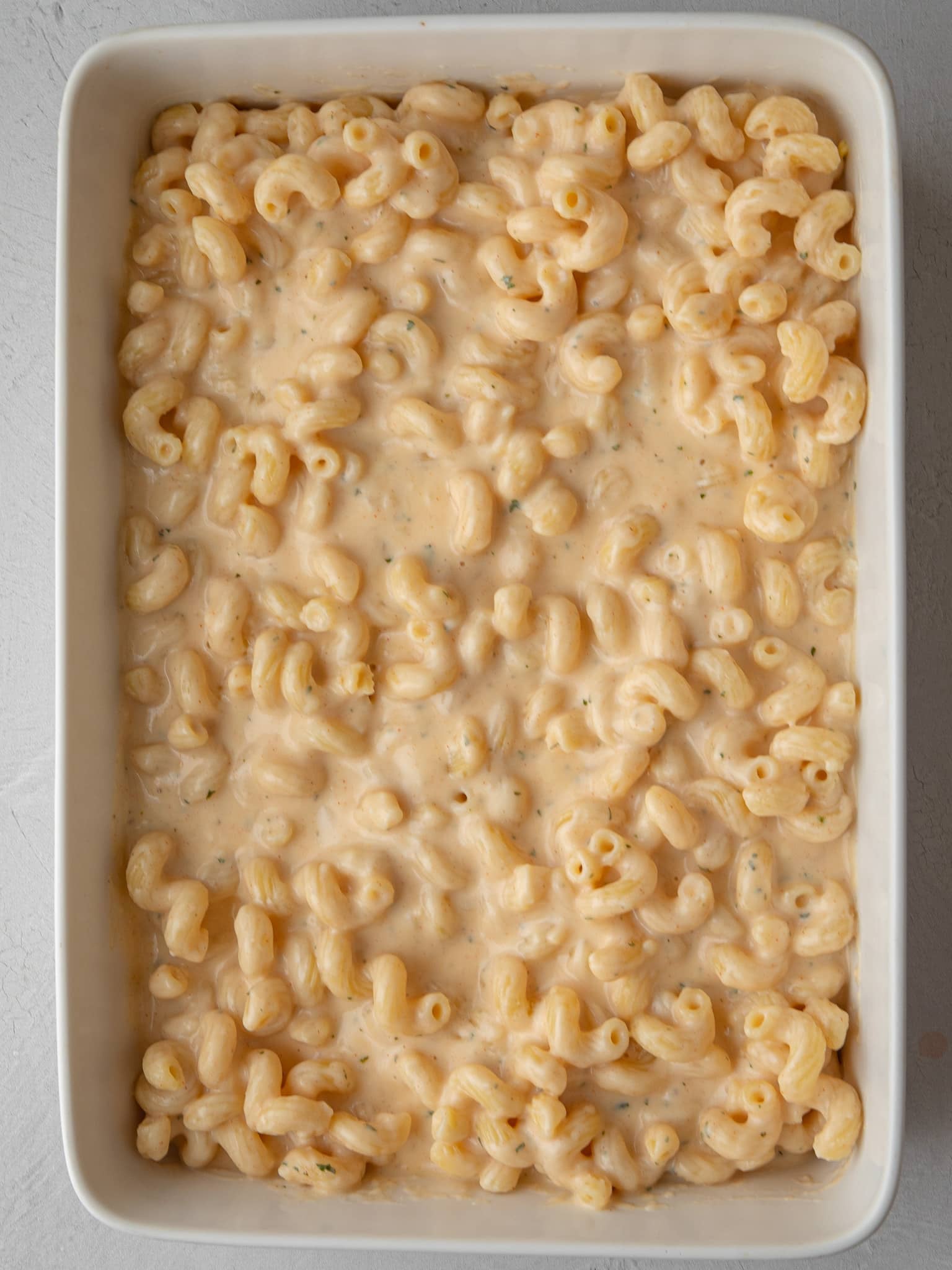 Creamy cavatappi mac and cheese spread in a baking dish