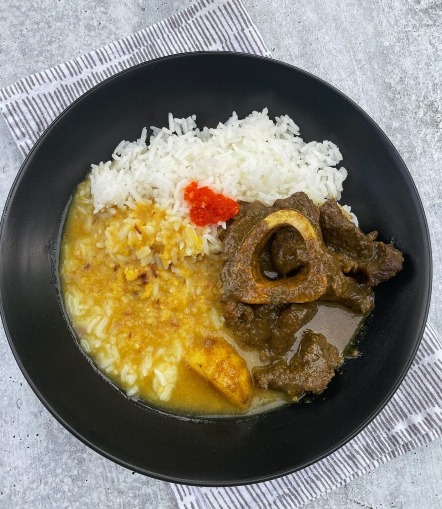 plated beef curry with rice and mango achar