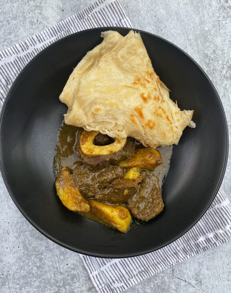 plated beef curry with roti