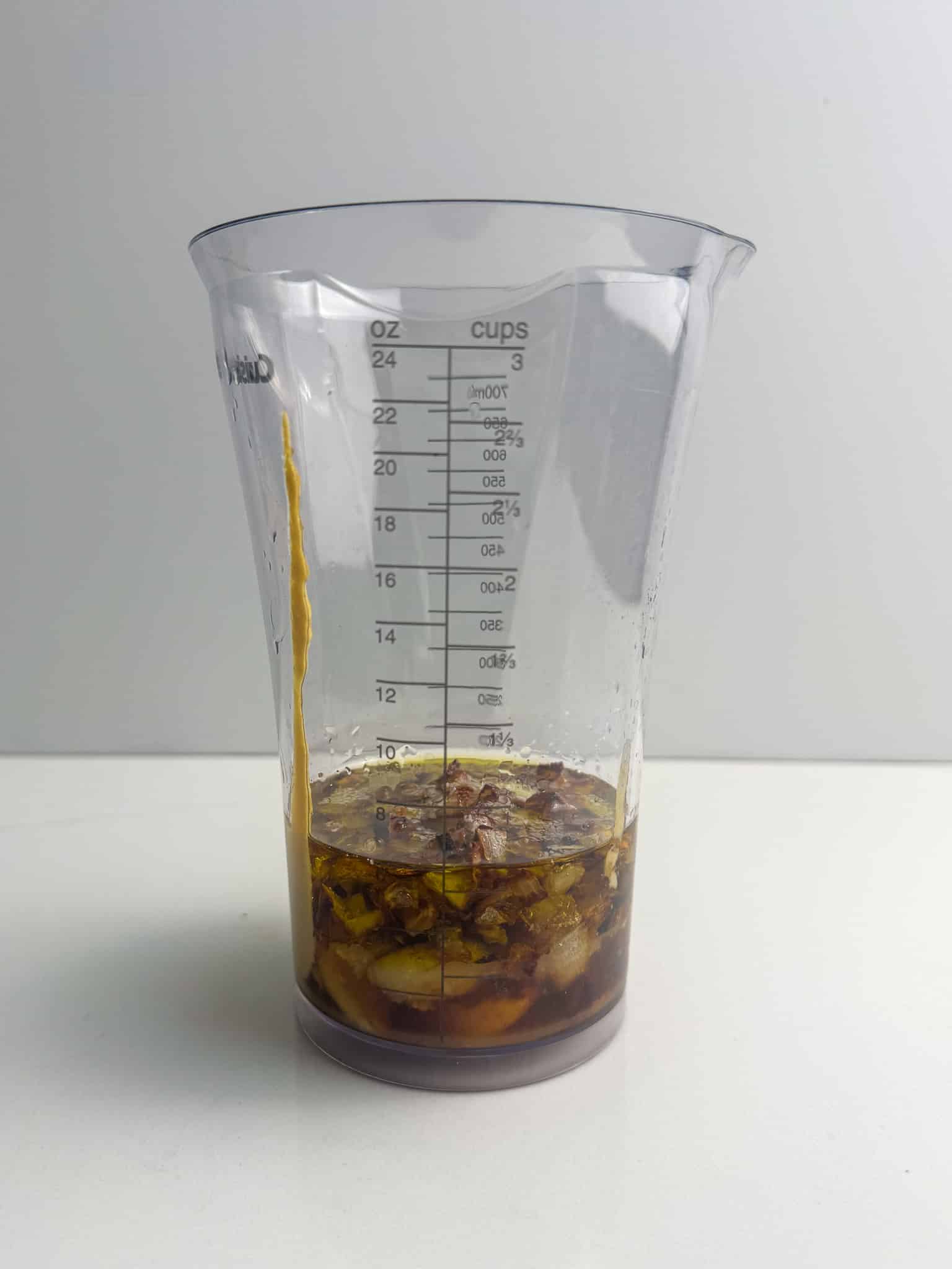 ingredients for caramelized onion dressing in a measuring cup before blending