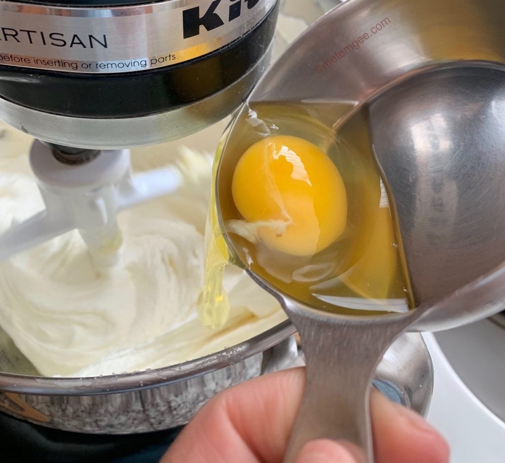 gradually adding eggs to creamed butter and sugar mixture