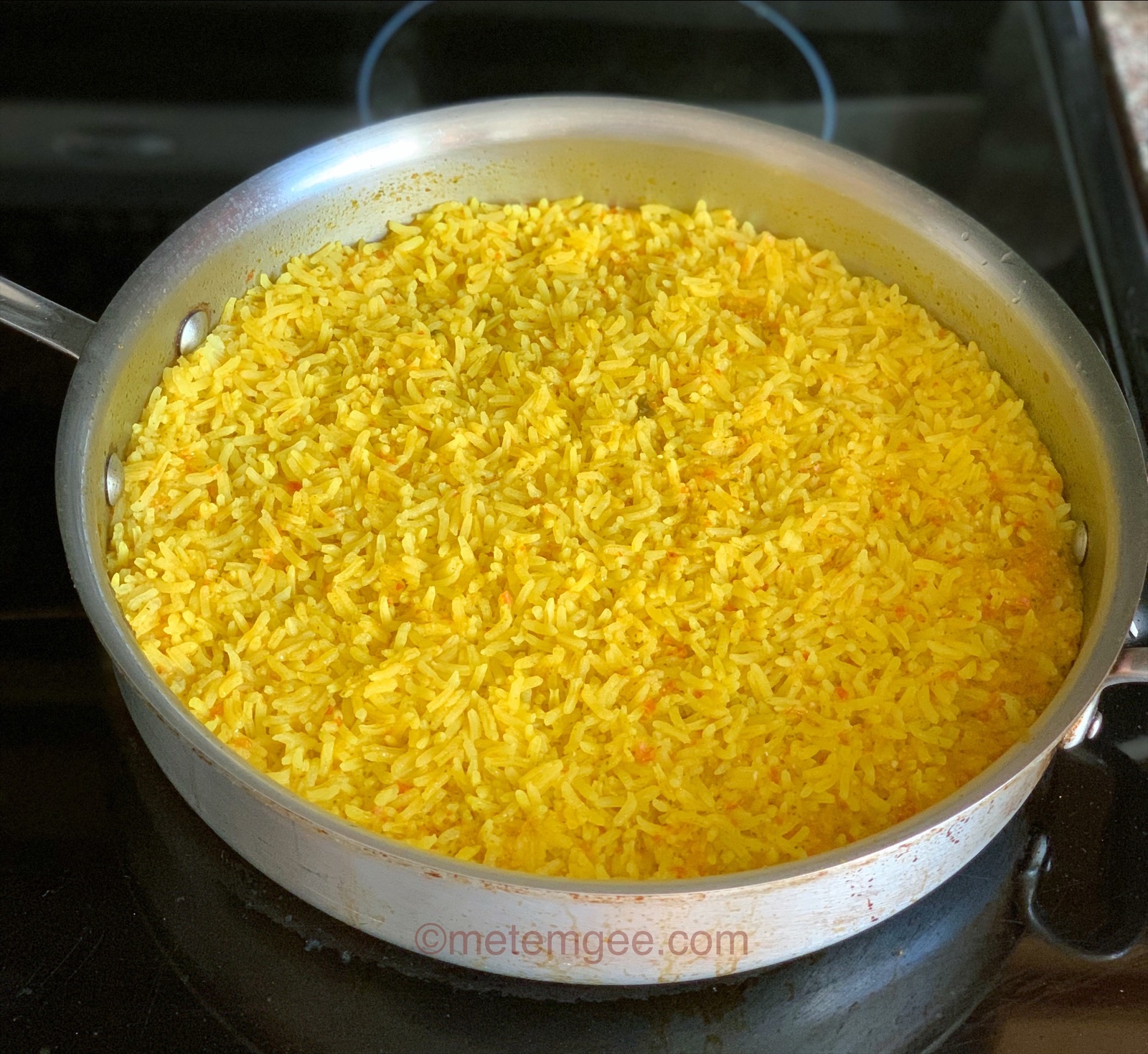 cooked yellow rice in a skillet