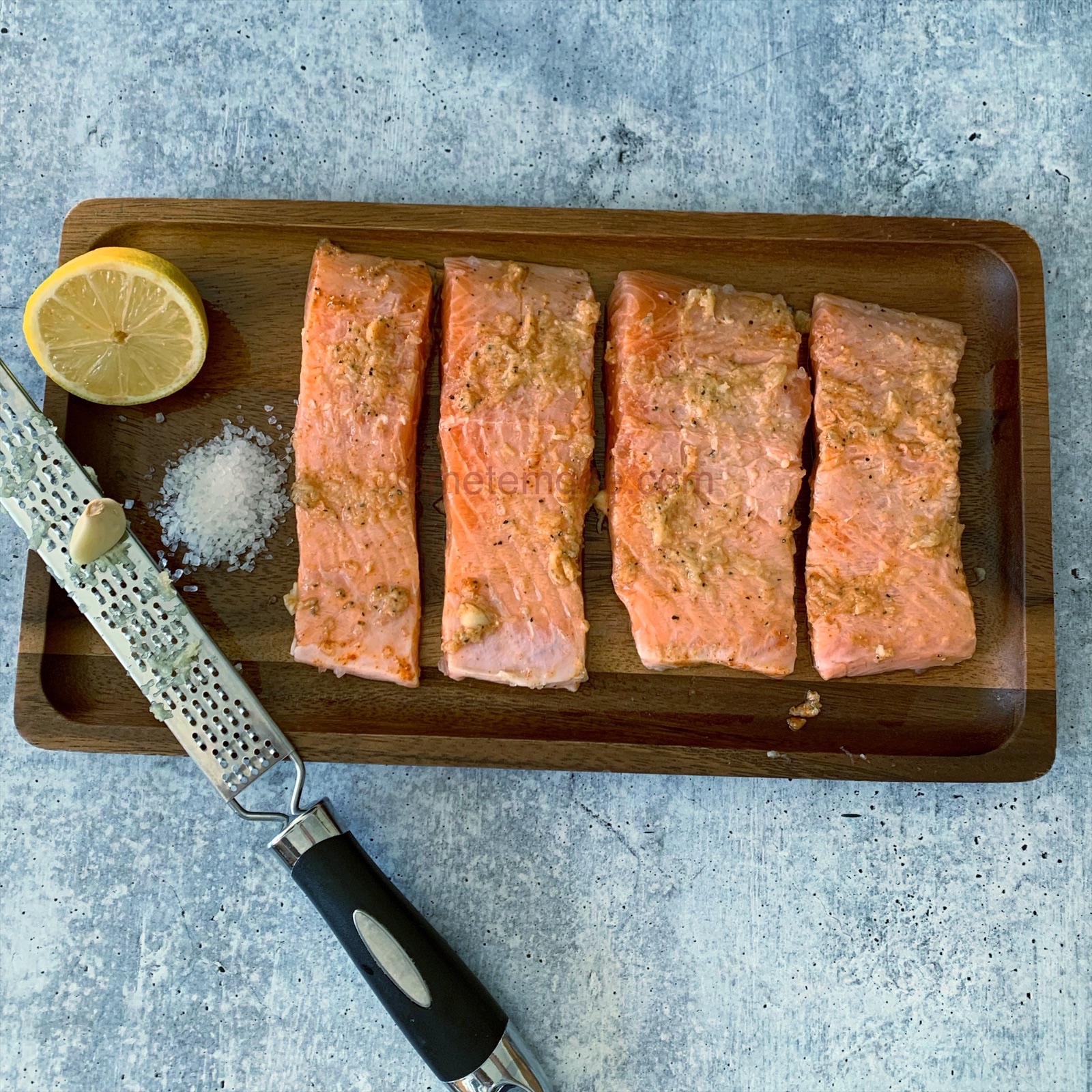 seasoned salmon filets on a cutting board