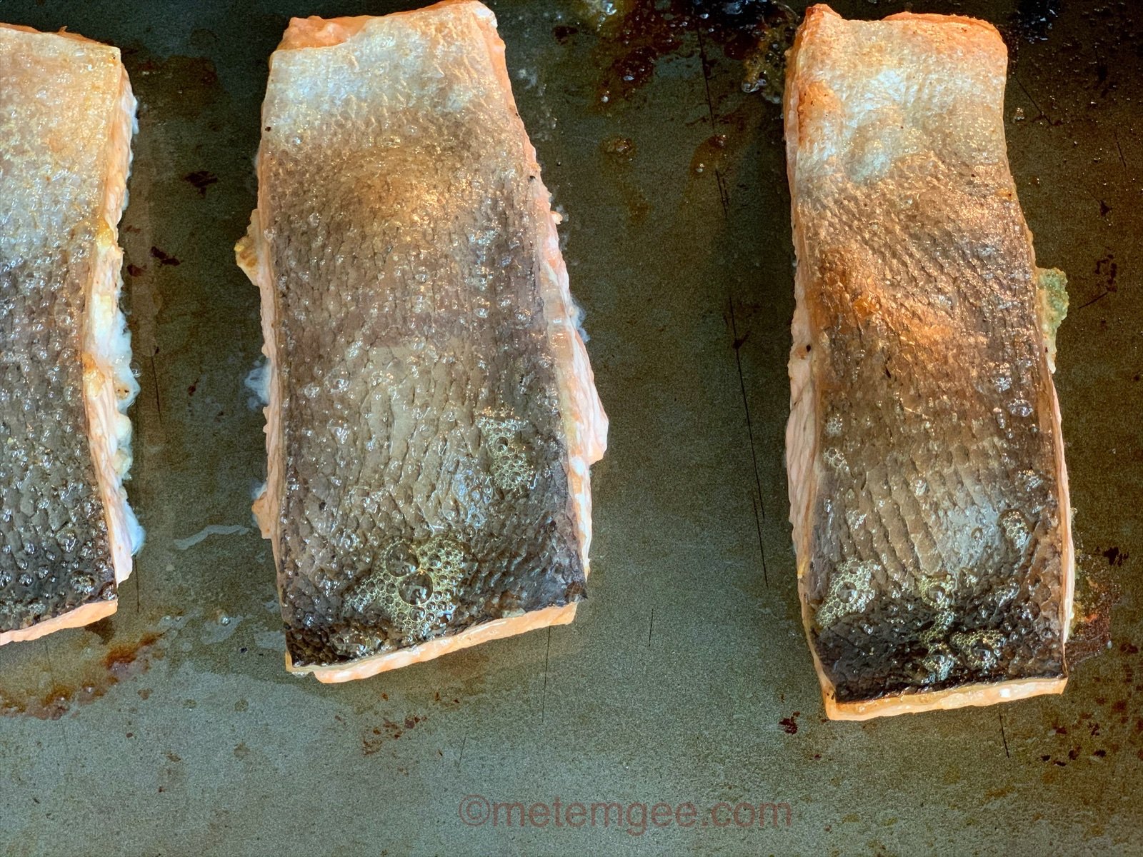 close up view of salmon broiling in oven
