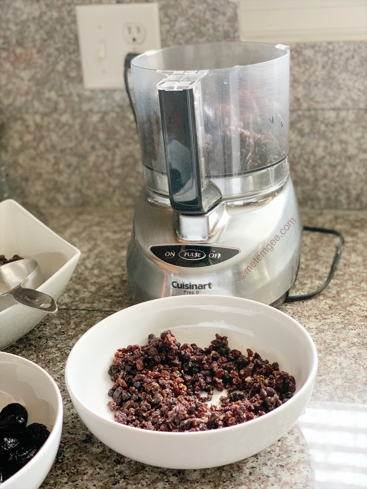 dried fruits being added to a food processor