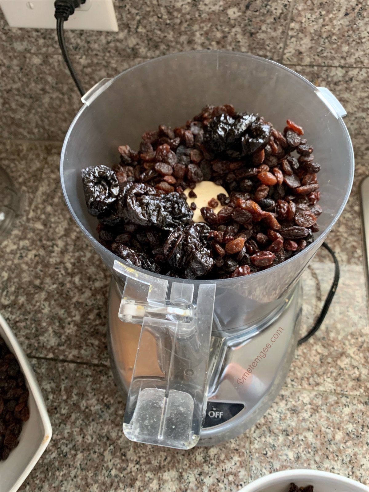 dried fruits being added to a food processor