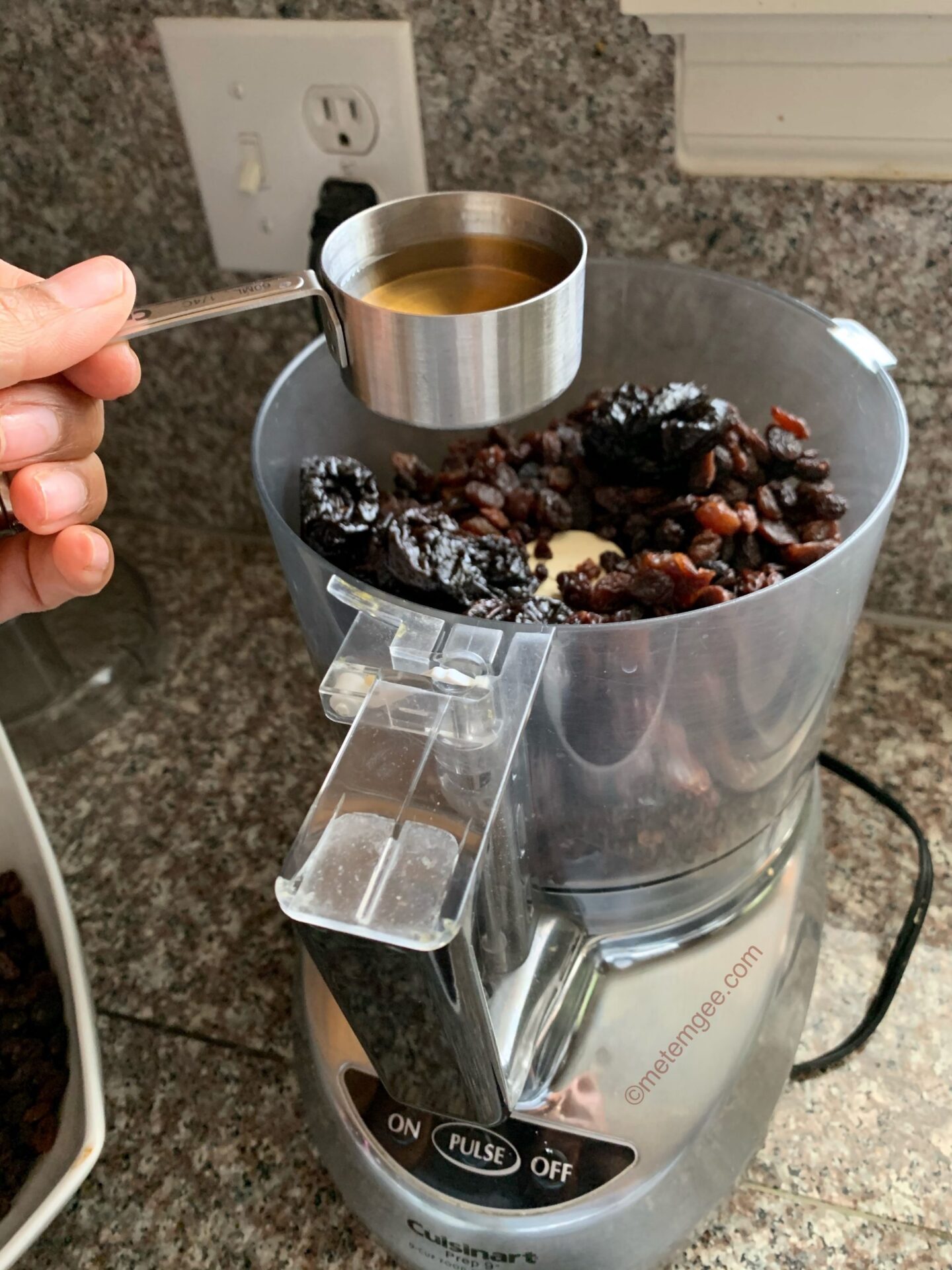 adding alcohol to dried fruit in the processor for soaked fruits recipe