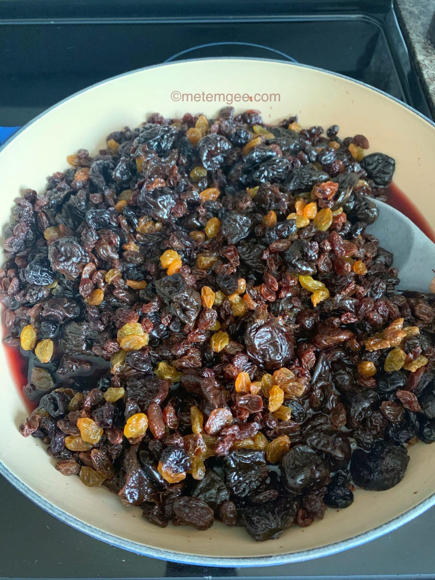 close up view of dried fruits soaking in red wine