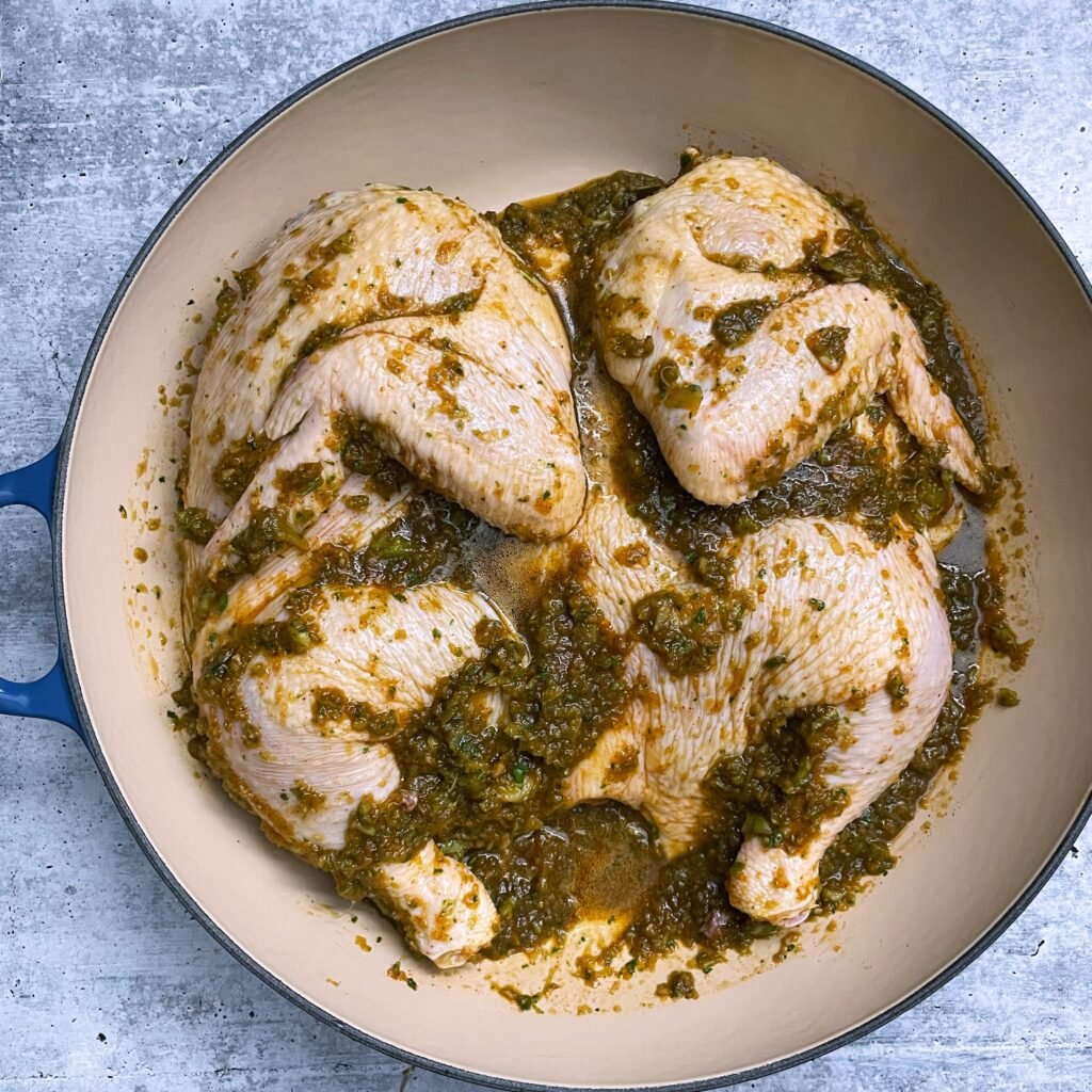 raw spatchcock chicken with Caribbean green seasoning 