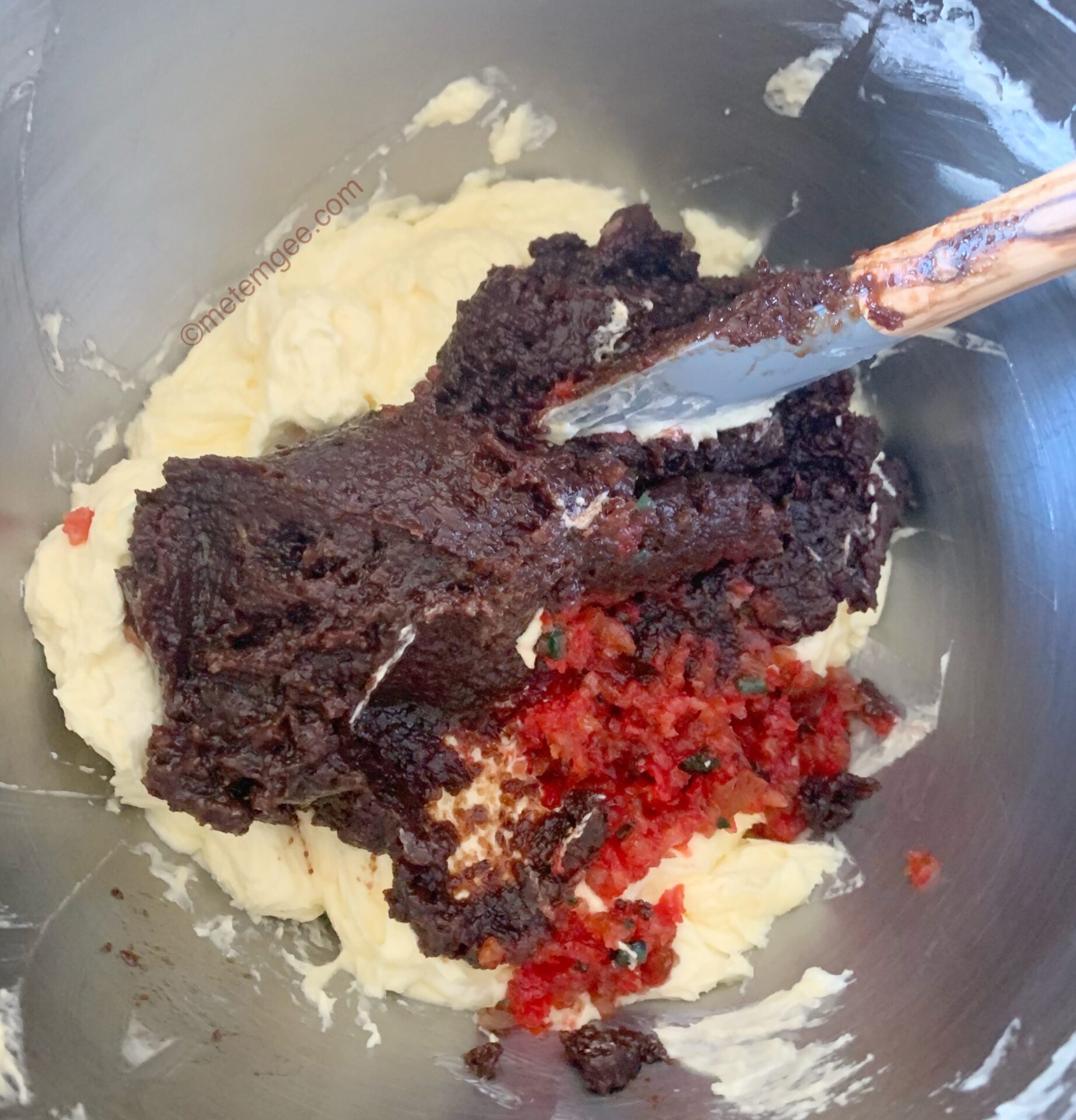 adding fruit paste to creamed butter