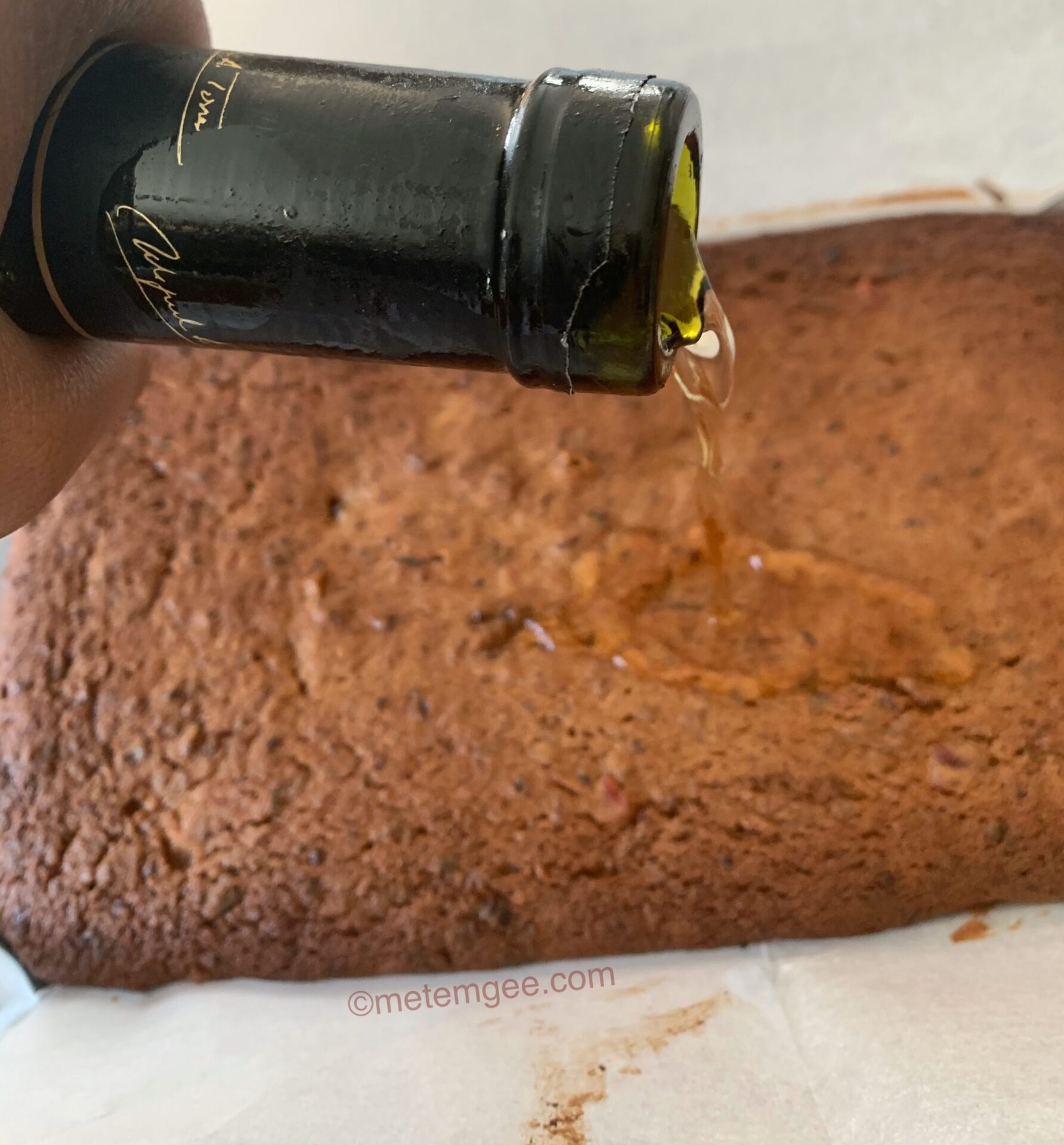 Adding Orange Liqueur to the Fruit Cake