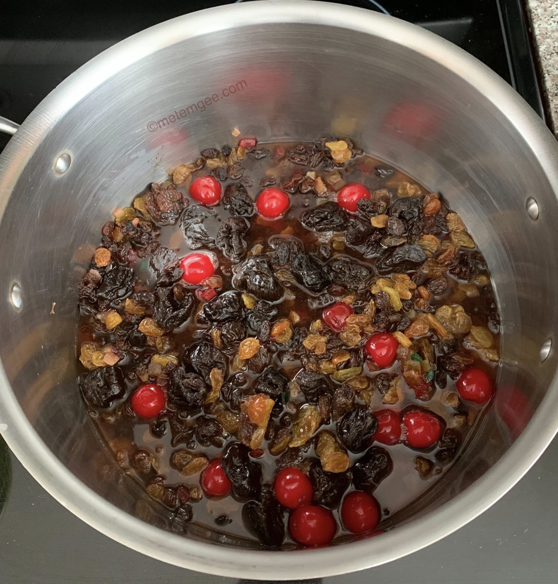 dried fruit cooking in a pot with wine