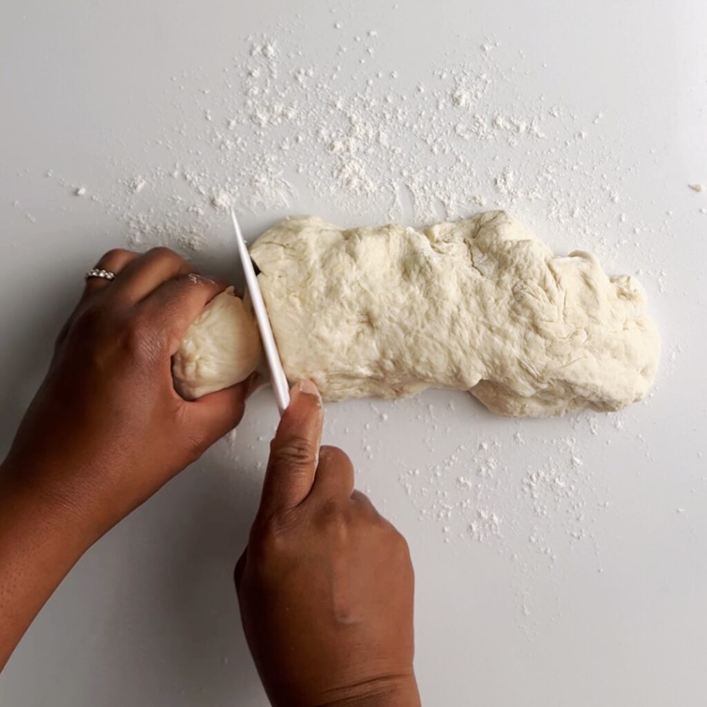 slicing kneaded dough for oil roti