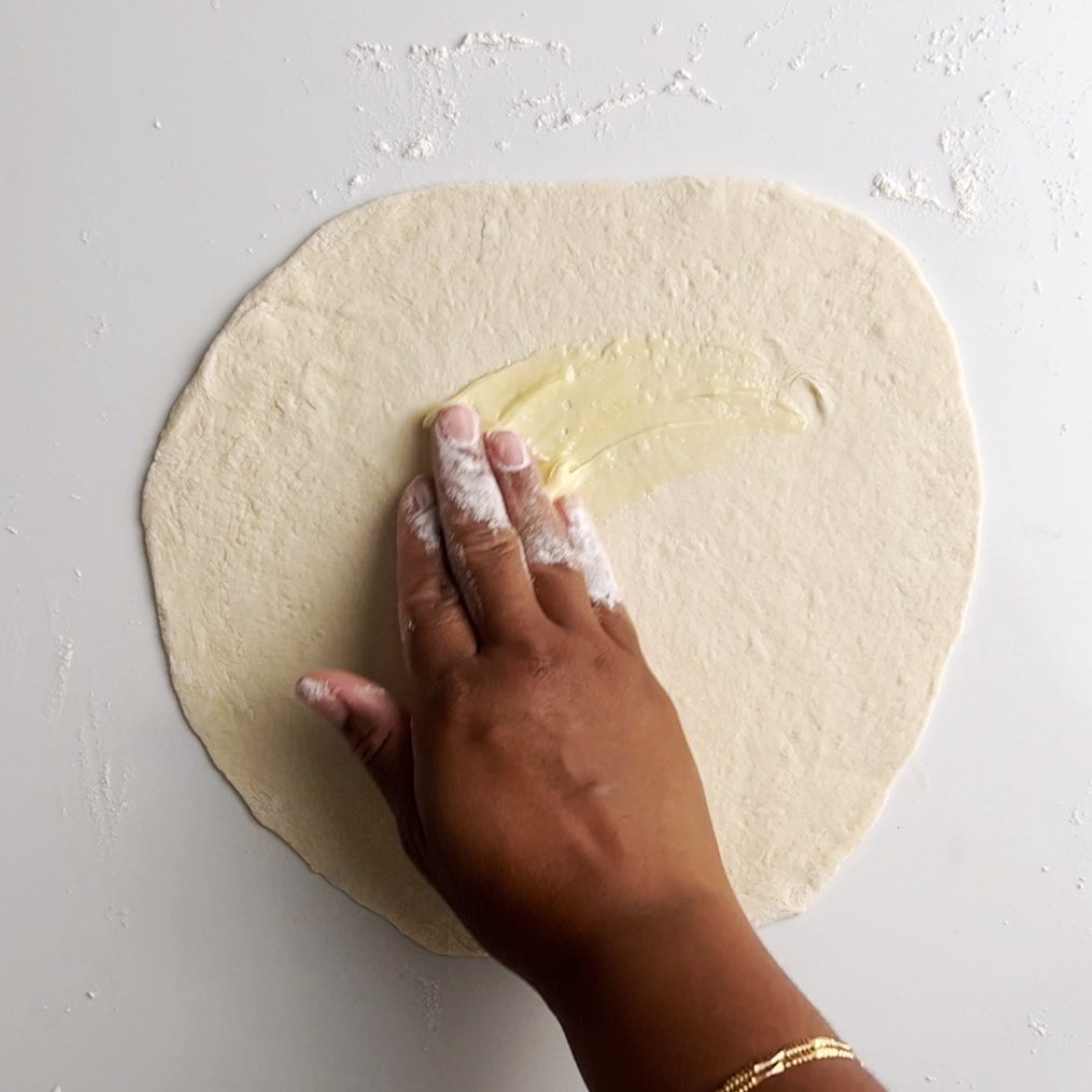 Add about 1 tablespoon of fat to the rolled out dough, brush the fat over the entire surface of the rolled out dough.