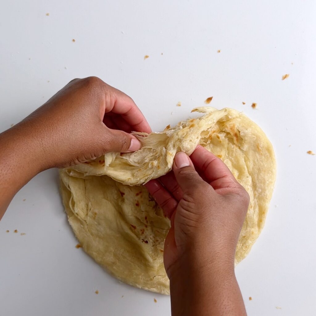 Roti after clapping showing the flaky layers