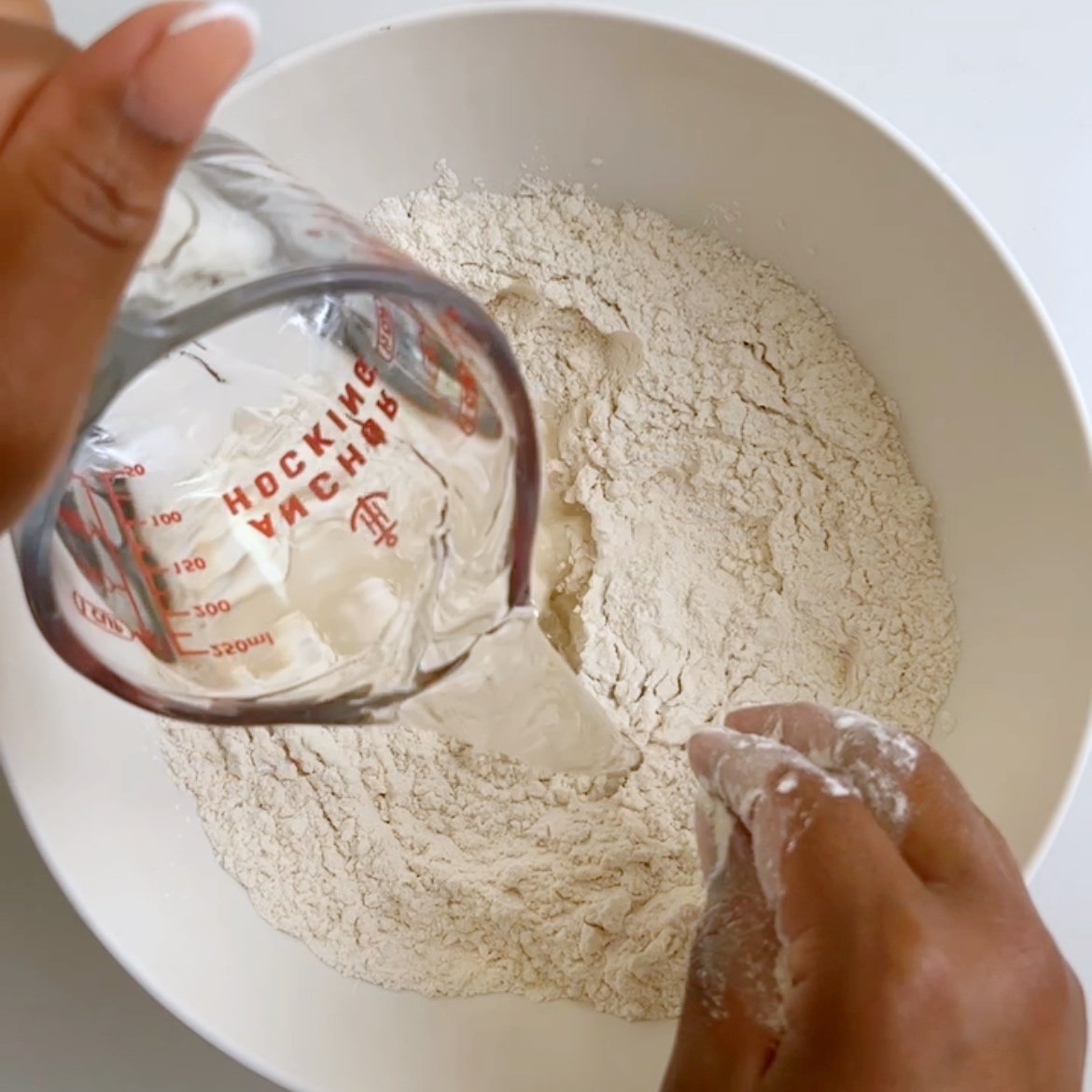water being poured into dry ingredients