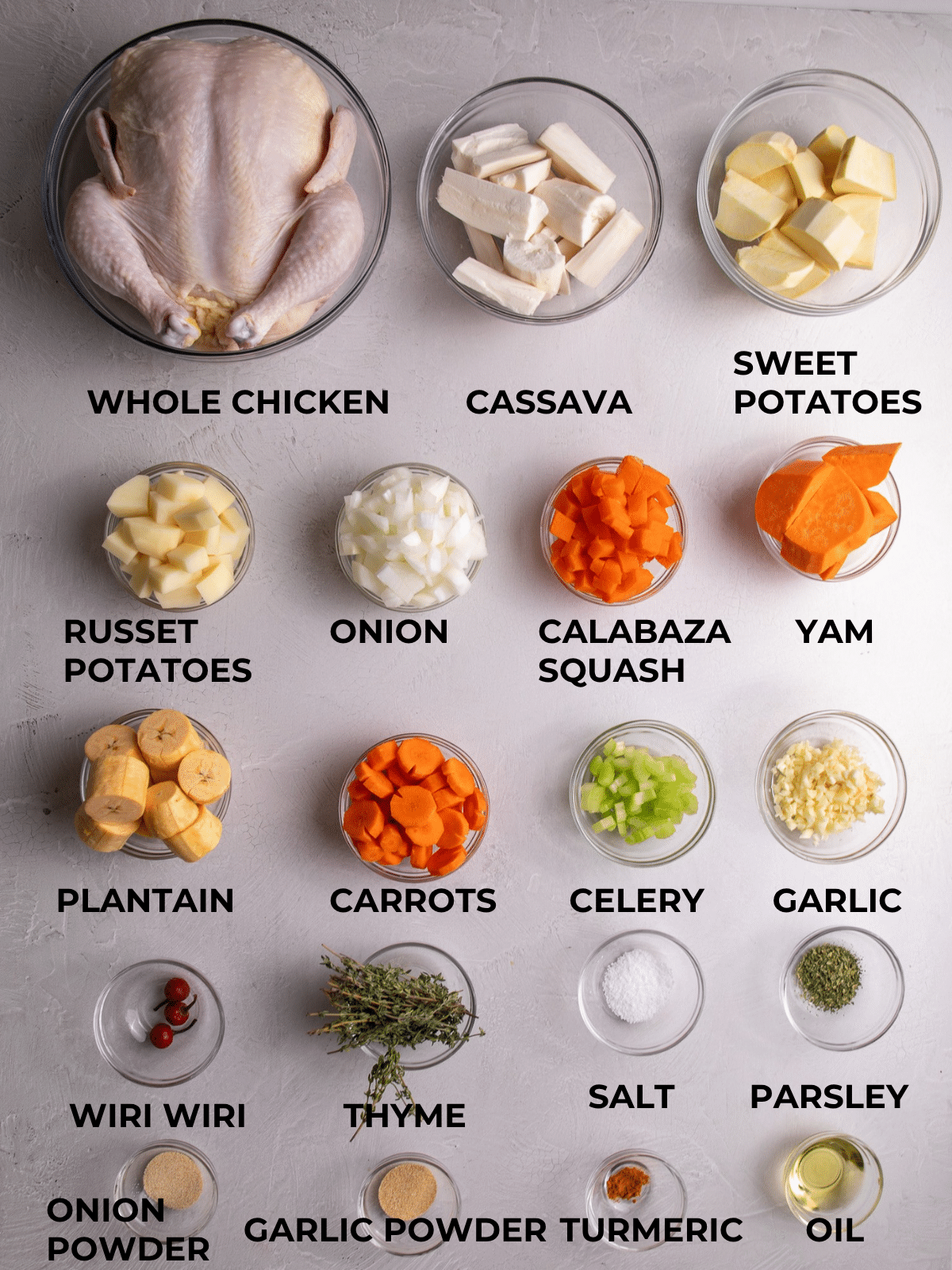 Ingredients for Caribbean chicken soup including whole chicken, cassava, sweet potatoes, yam, plantain, carrots, onion, garlic, thyme, and spices
