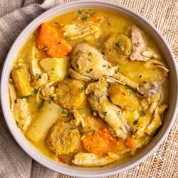 Caribbean chicken soup with root vegetables, plantains, and bone-in chicken in a rich golden broth