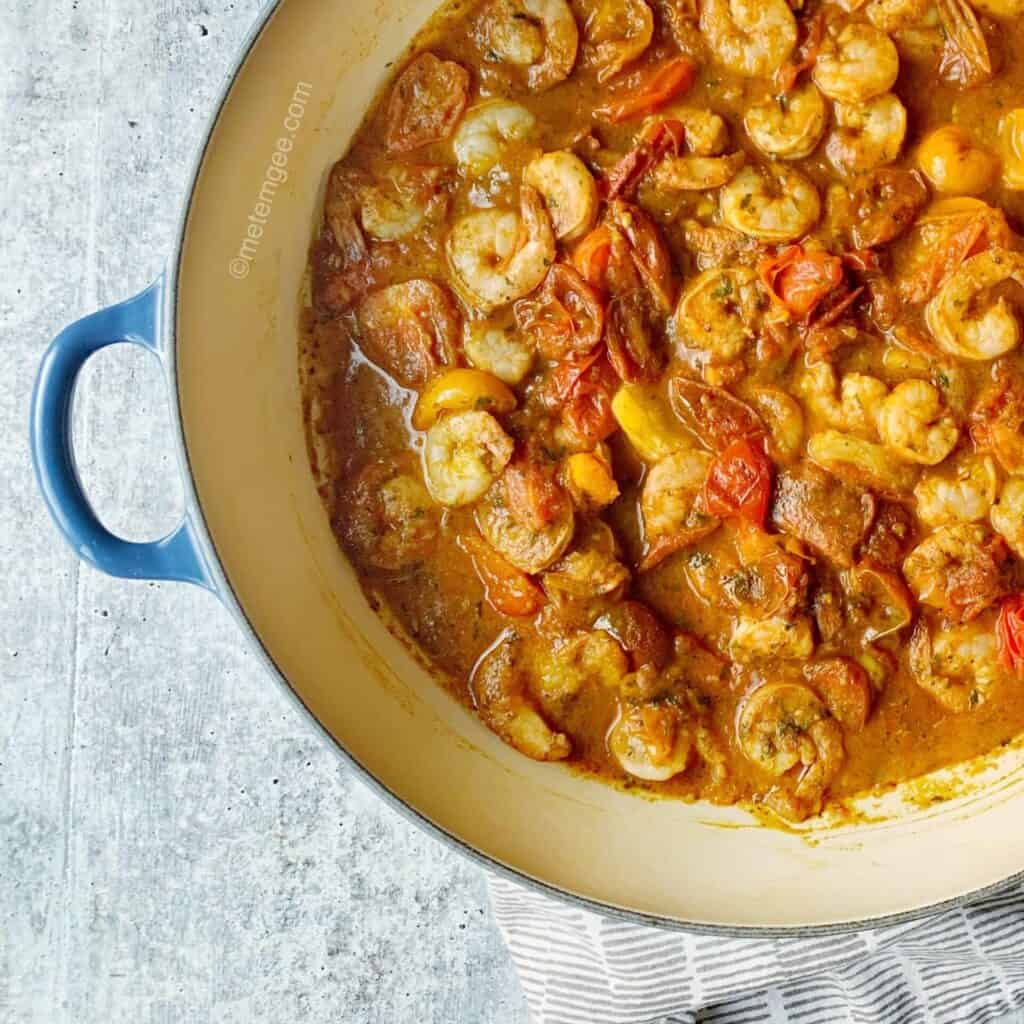 a pot full of shrimp and tomato stew